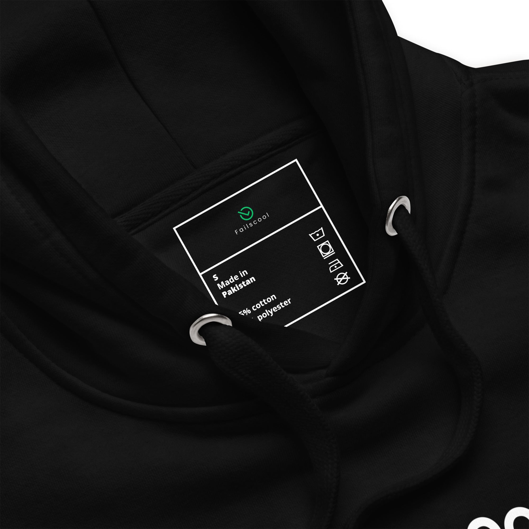 Close-up of the inside label on the black Failscool premium hoodie with the text “Made by failures. Worn by learners.” Minimalist detail highlighting craftsmanship, authenticity, and the Failscool philosophy of growth through failure.