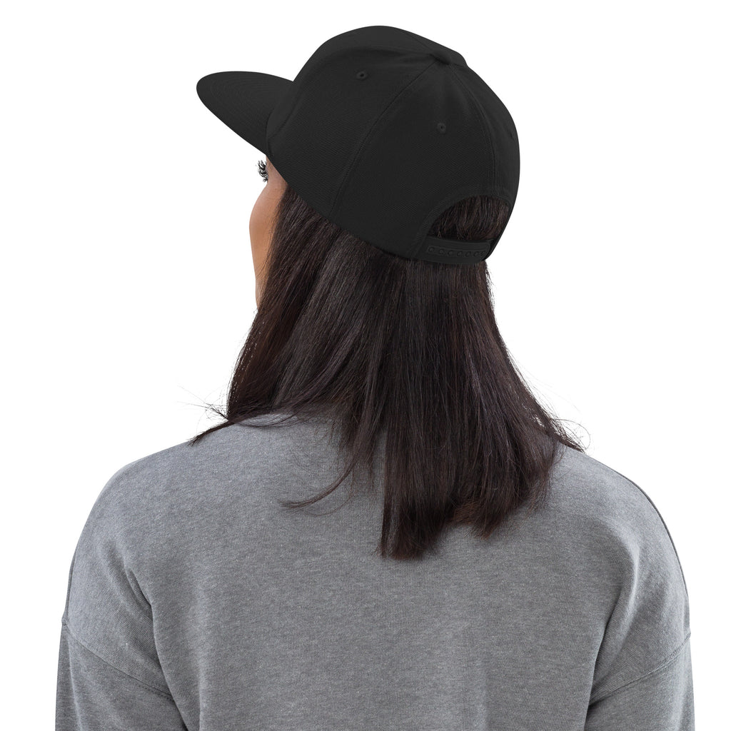 Back view of female model wearing the Failscool snapback hat. Adjustable snap closure and structured silhouette for a sleek urban look.