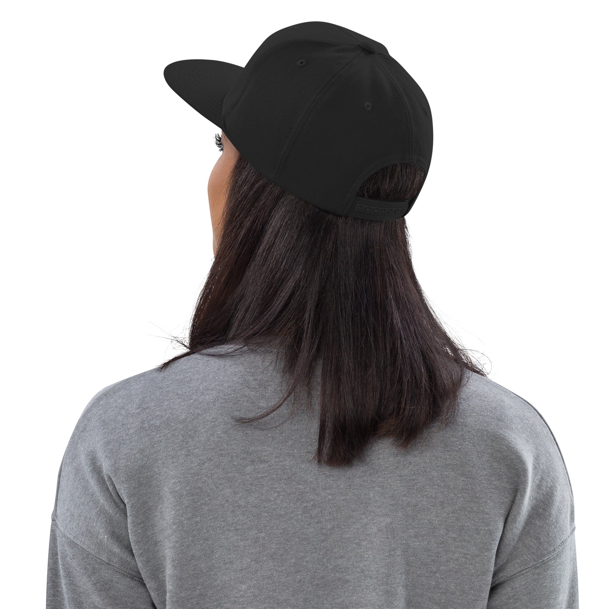 Back view of female model wearing the Failscool snapback hat. Adjustable snap closure and structured silhouette for a sleek urban look.