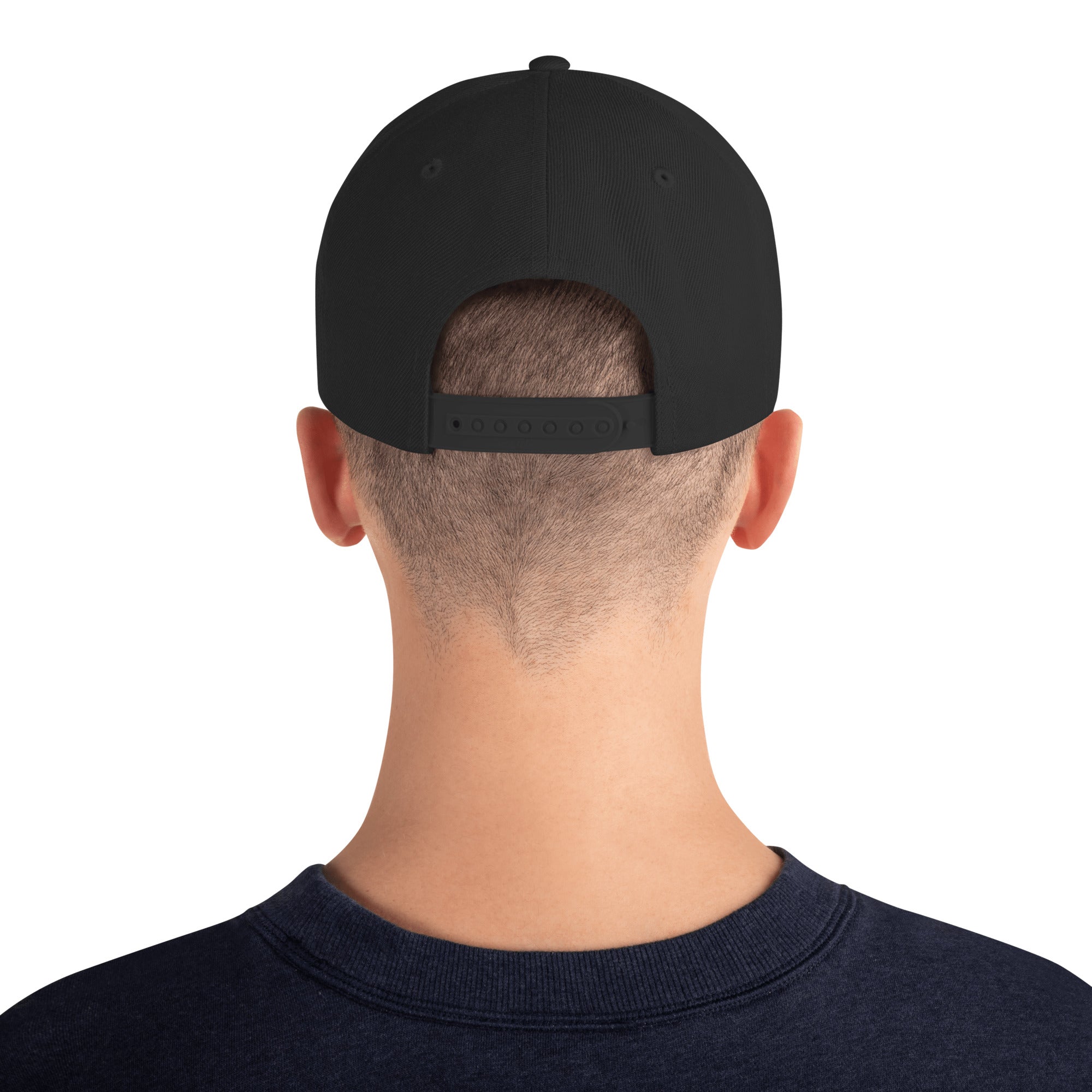 Back view of male model wearing the black Failscool snapback hat. Adjustable strap and subtle branding emphasize clean, universal style.