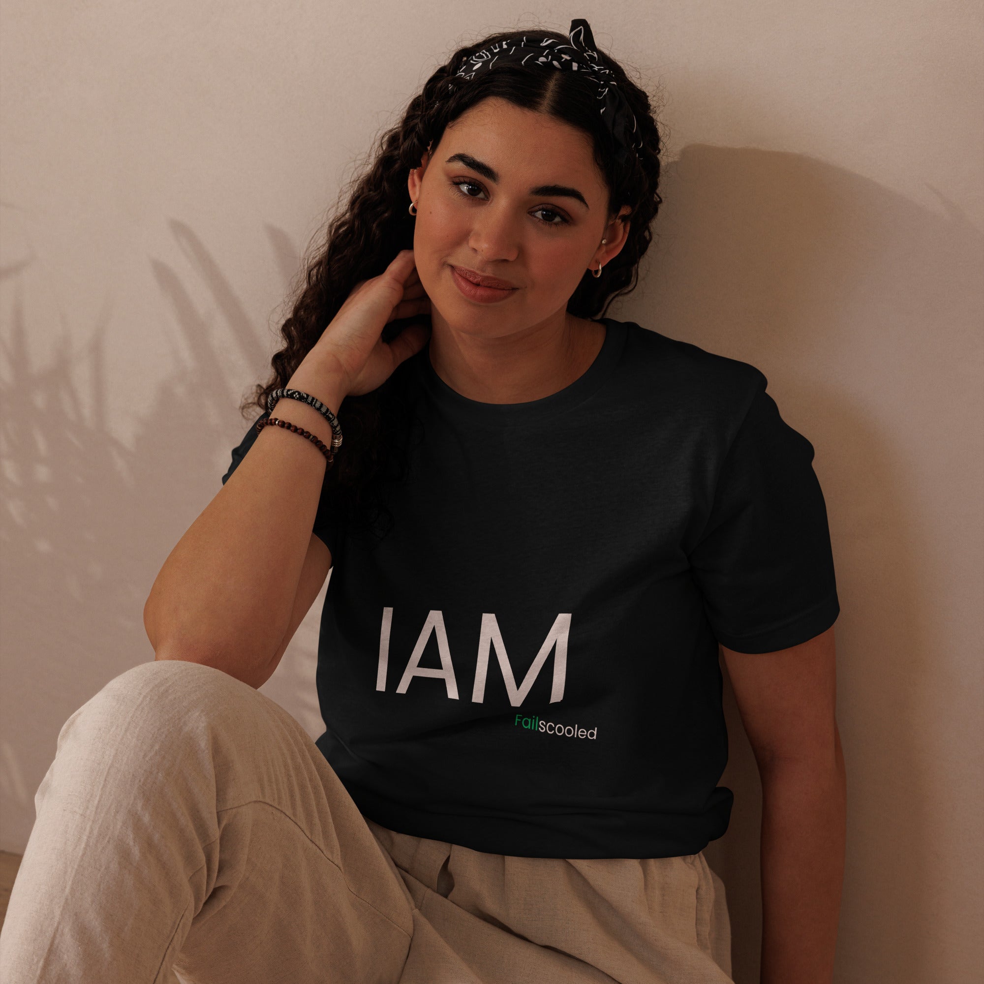 Female model in black Failscool t-shirt with the white print “I AM FAILSCOOLED.” Soft, sustainable, and empowering fashion for real learners.