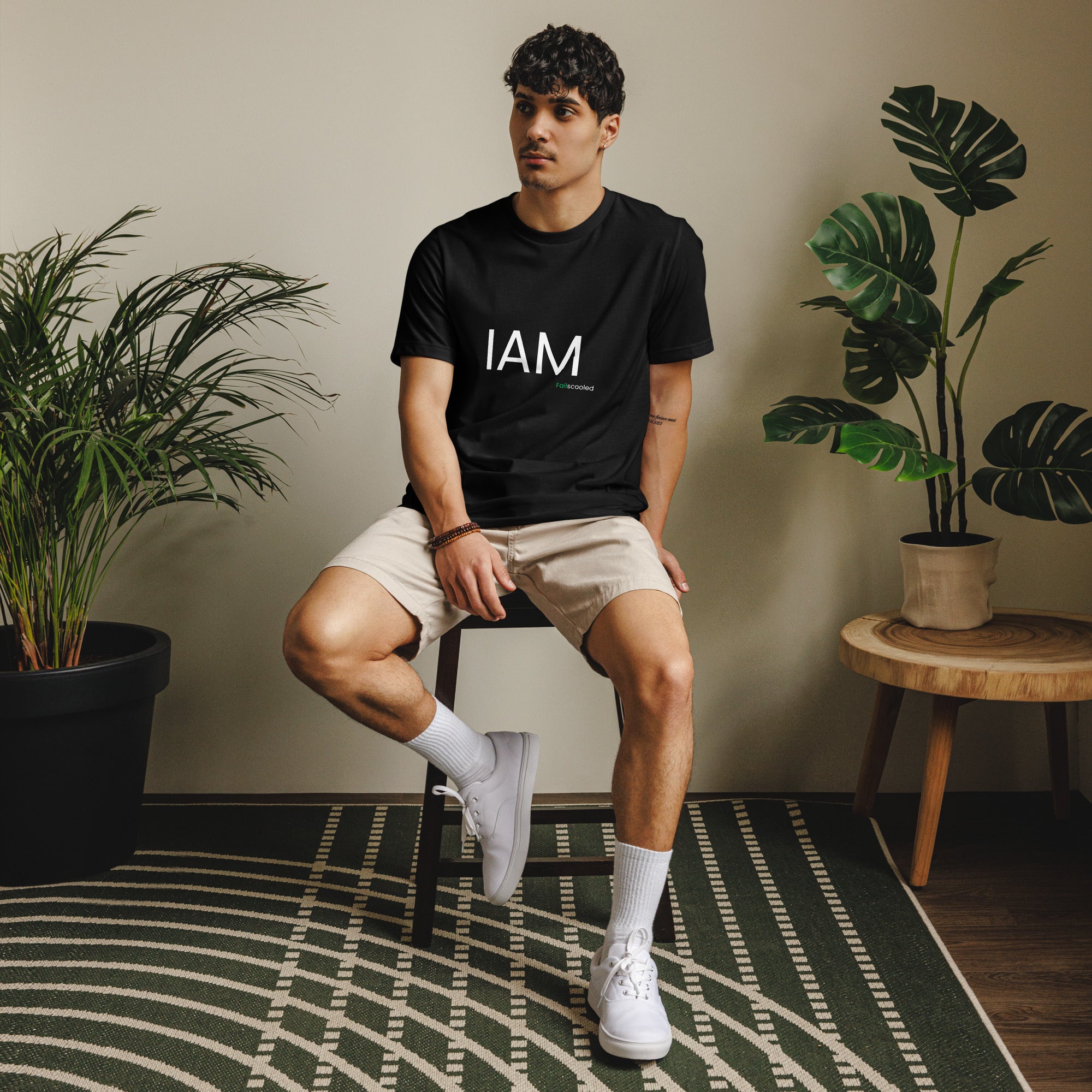 Male model wearing a black Failscool t-shirt with the white text “I AM FAILSCOOLED.” Confident eco streetwear for self-aware creators.
